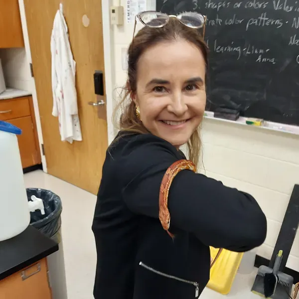 a smiling woman holding a snake