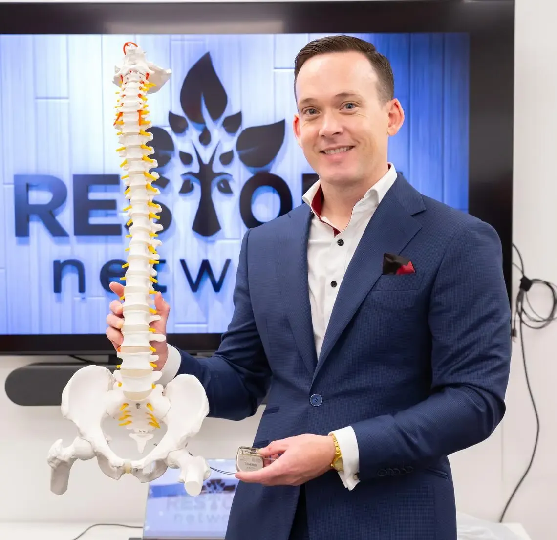 Aaron Phillips holding a spinal column